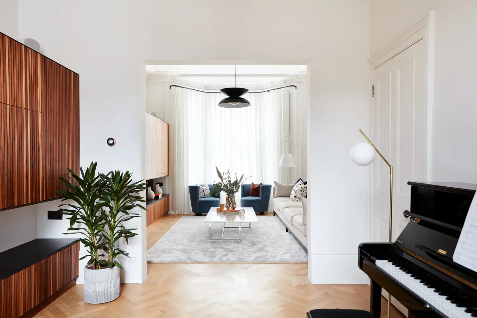 Flip-Down Desks Fold Out of This Home’s Fluted Wood Wall Like Tray Tables