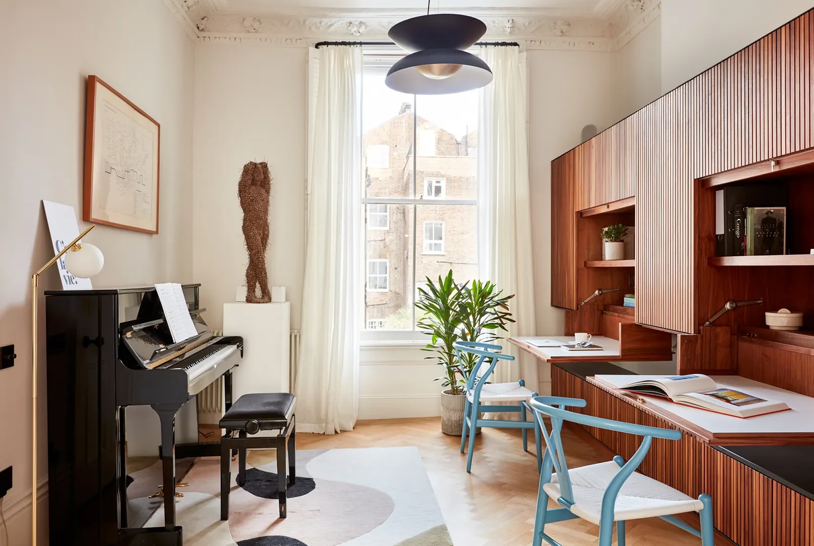 There are two desks in this London living room, but you’d never know it.
